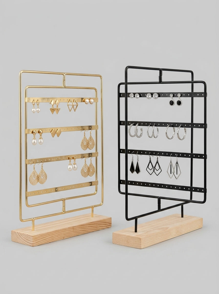 Gold and black metal earring display stands with wooden base